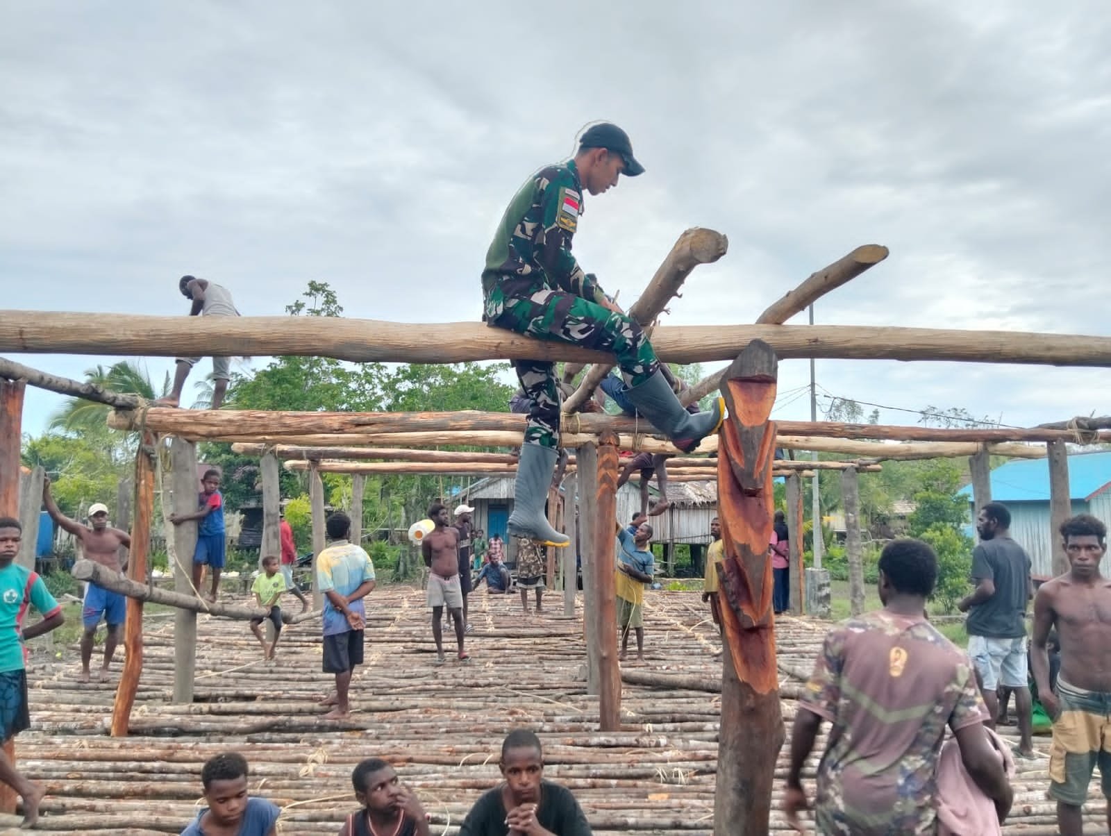 Prajurit Satgas Yonif 123/Rajawali membantu warga membangun Rumah Adat Jew di Kampung Basim Asmat. - thewasesanews.com