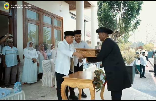 Bupati Ikram Malan Sangadji menyerahkan bendera pataka kepada para Sangaji di Halmahera Tengah.